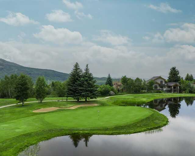 A view of a green surrounded by water at Rollingstone Ranch Golf Club.