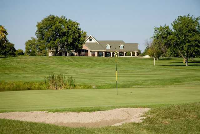 A view of a green with clubhouse in background at Hickory Point Golf Course