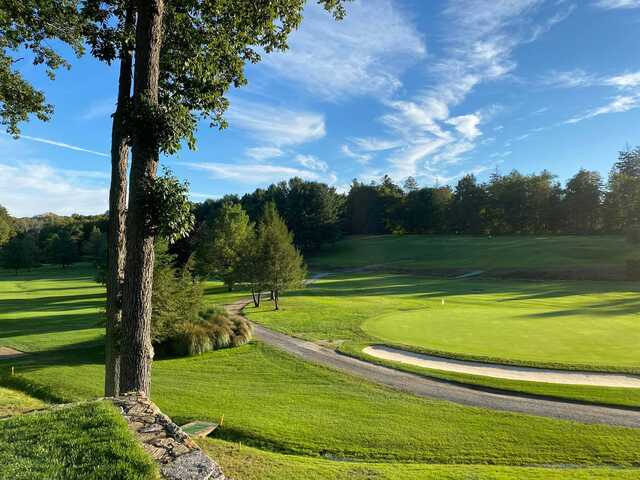 A sunny day view of a green at Newtown Country Club.