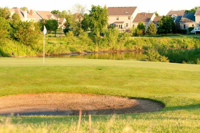 A view of a green with water in background at Mill Creek Golf Club