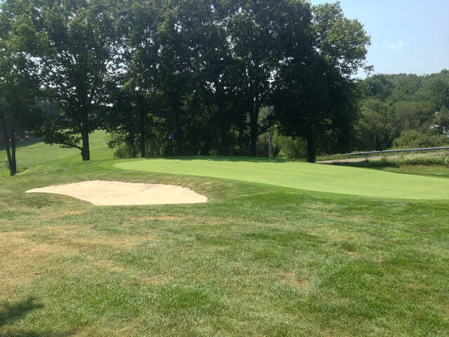 A sunny day view of a hole at Highland Golf Club.