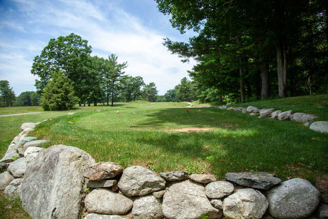 A sunny day view of a tee at Harrisville Golf Course.