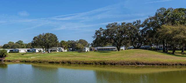 A view of a green surrounded by water at Hamptons Golf Club.
