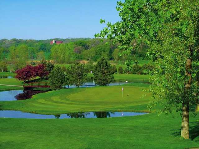 A view of green #8 surrounded by water at Prairie Isle Golf Club