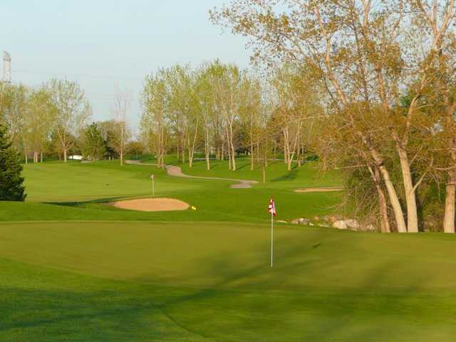 A sunny view of greens with narrow path on the right background at Prairie Isle Golf Club