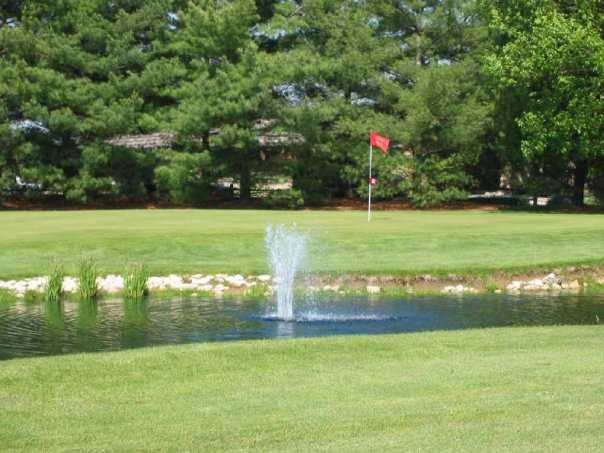 A view over the water of a green at Quail Meadows Golf Course