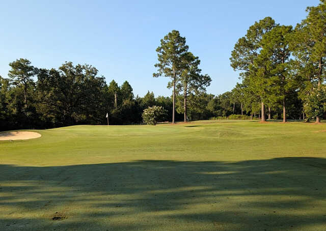 A sunny day view of a green at Uchee Trail Country Club.