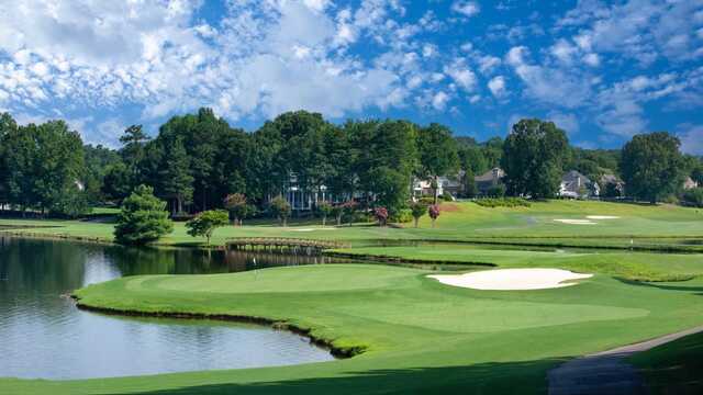 A view of a green surrounded by water at Planterra Ridge Golf Club.