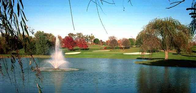 A view of a hole protected by bunkers with a water fountain in foreground at Beckett Ridge Country Club