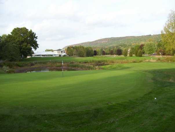 A view of a hole with water in background at Blue Fox Run Golf Club