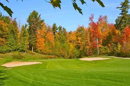 A view of green 13 flanked by bunkers at Glacier Wood Golf Club