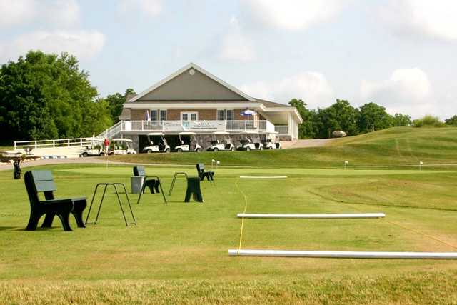 A view of the driving range and clubhouse in background at Willow Wood Golf Club