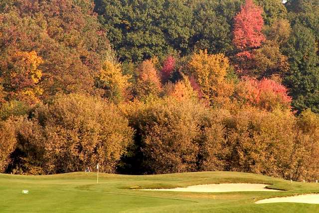 A fall view of green protected by bunkers at Willow Wood Golf Club