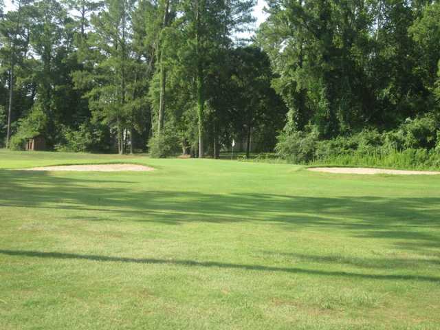A view of green flanked by bunkers at Livingston Golf Course