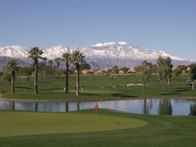 Big Rock Golf & Pub at Indian Springs: #18 green in foreground with #15 green and hole on the other side of the lake. Mt. San Jacinto covered in snow in the background