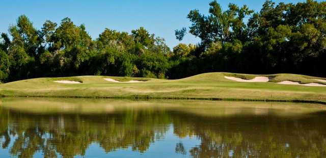 A view over the water of a green at Quail Valley Golf Course