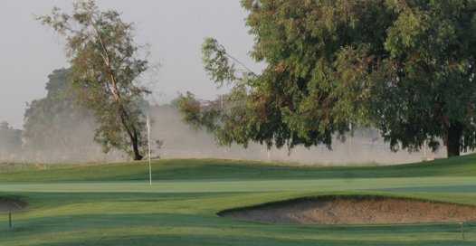 A view of a green protected by bunker at Lemoore Golf Course.