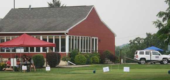 A view of the clubhouse and the putting green at Wynding Brook Golf Club
