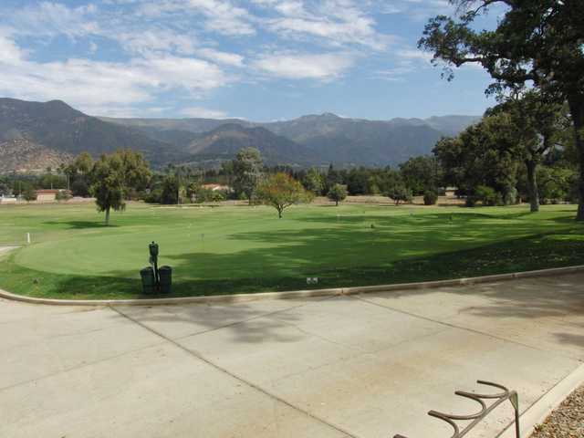 A view of the practice putting green with mountains in background at Soule Park Golf Club