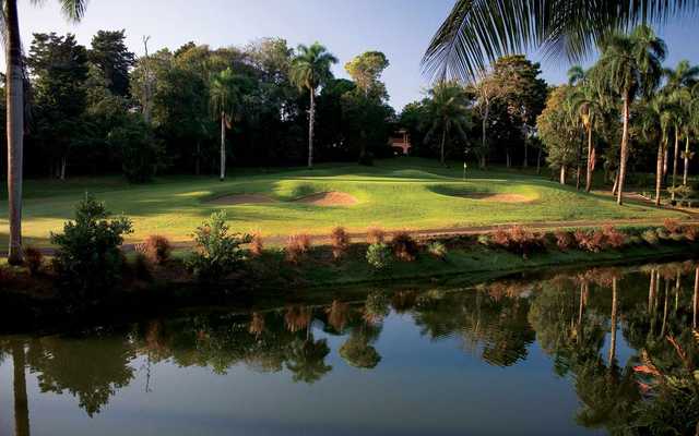 A view over the water of a green protected by bunkers from Sugarcane course at TPC Dorado Beach