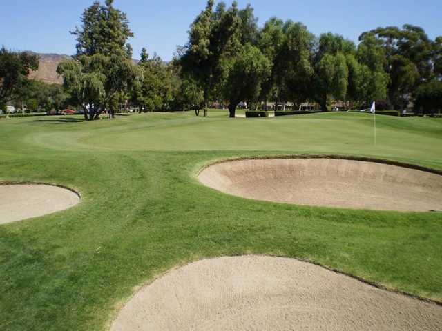 A view of a green protected by bunkers at Arrowhead Country Club
