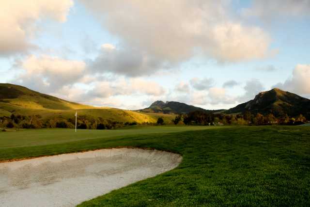 A view of a green protected by bunkers at Dairy Creek Golf Course.