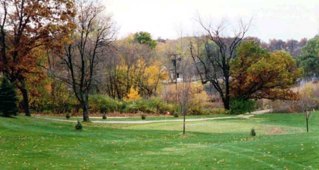 A fall view of green with narrow path in background at Highland Hills Golf Club