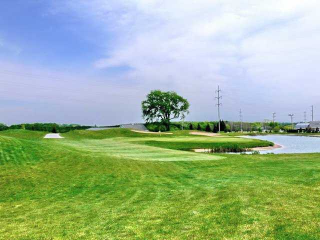 A view from fairway #18 of the green surrounded by water at Crown Golf Course