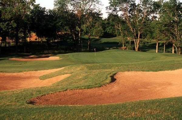 A view of a green protected by sand traps at Shoal Creek Golf Course.