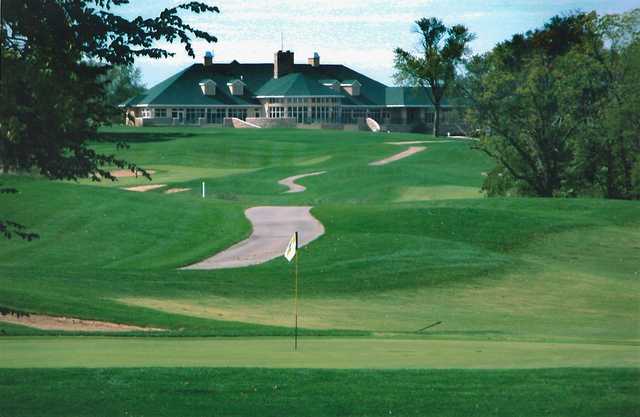 A view of the clubhouse with green in foreground at Tiffany Greens Golf Club