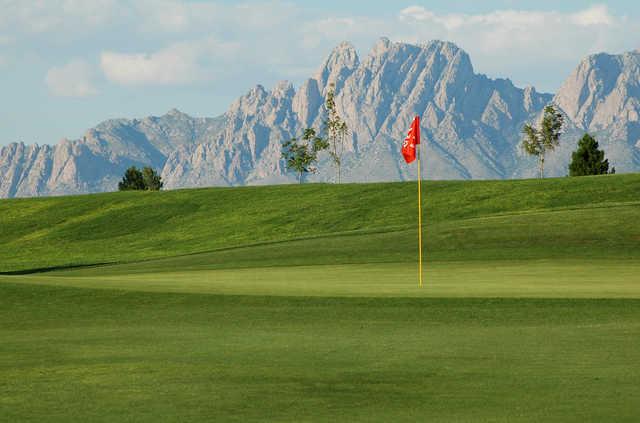 A view of a green with beautiful mountains in background at New Mexico State University Golf Course