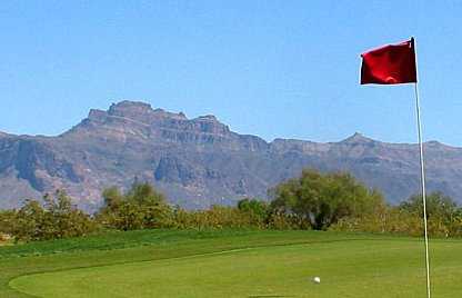 A view from green with mountains in background at Apache Creek Golf Club