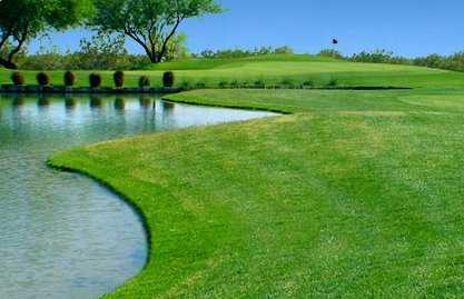A view of a hole with water on the left side at Apache Creek Golf Club