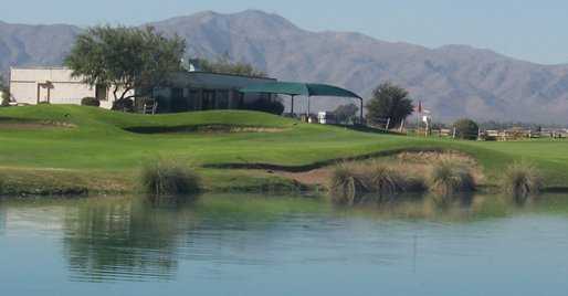 A view over the water of the clubhouse with mountains in background at Falcon Golf Club
