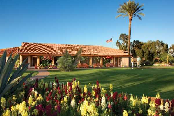 A view of the clubhouse and putting green at 	Rancho de Los Caballeros Golf Club