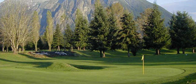 A view of green #18 with mountain in background at Mt. Si Golf Course.
