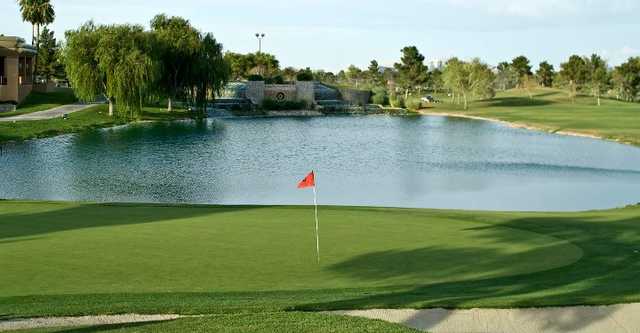 A view of a green with water in background at Spanish Trail Country Club