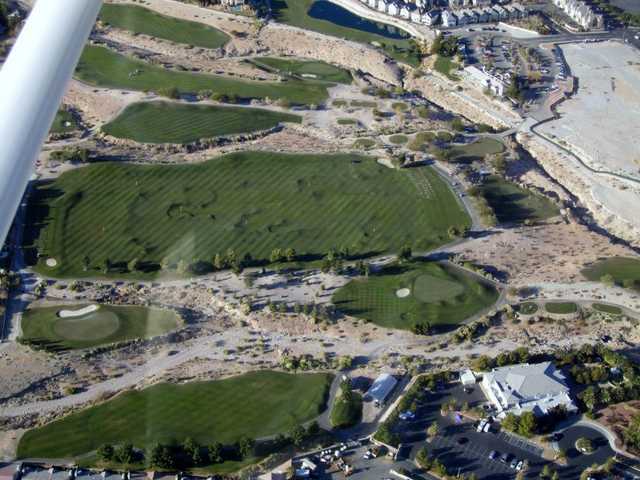 Aerial view of hole #6, clubhouse and the driving range at Desperado Course from Badlands Golf Club
