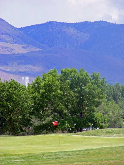 A view of a hole with mountains in background at Wildcreek Golf Course