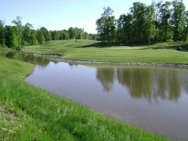 A view over the water of a hole at Champions Pointe Golf Club