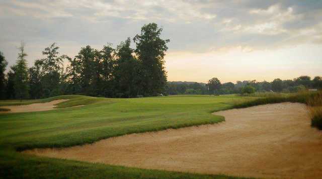 A view of green guarded by sand traps at Champions Pointe Golf Club