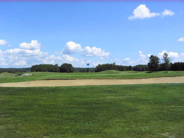 A view of a green protected by a sand trap at Red/Blue Course from Irish Hills Golf & Country Club.