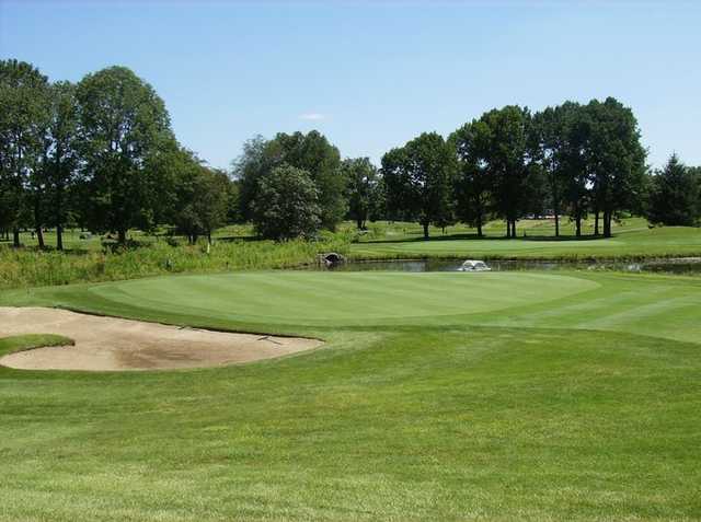 A view of green #14 guarded by sand trap at Shadowood Golf Course