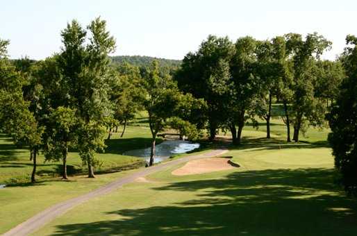 A view of a green protected by sand trap at Pryor Creek Golf Course