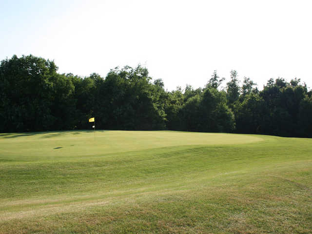 A sunny view of a green at Oaktree Golf Club