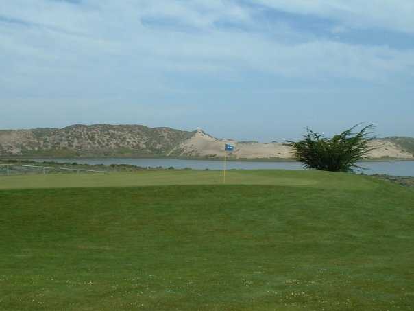 A view of a green with water in background at Sea Pines Golf Resort