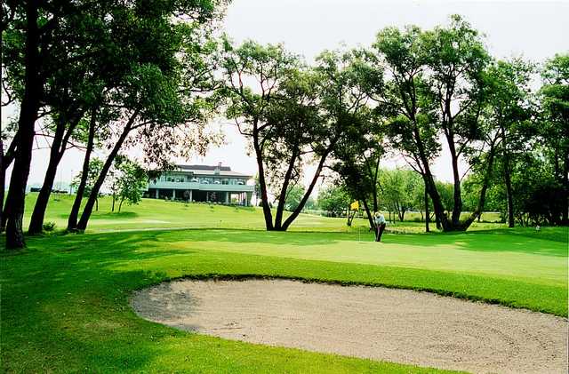 A view of the clubhouse with sand trap in foreground at Harmony Creek Golf Club