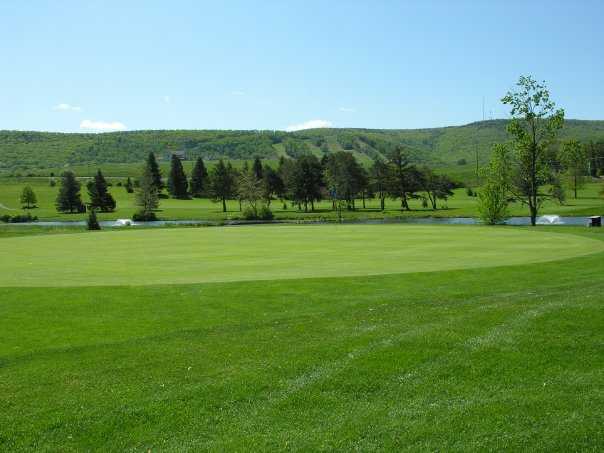 A view of a green with water fountain in background at Mountain View Country Club