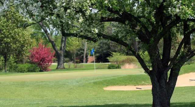 A spring view of a hole with a sand trap on the right side at Deer Path Golf Course