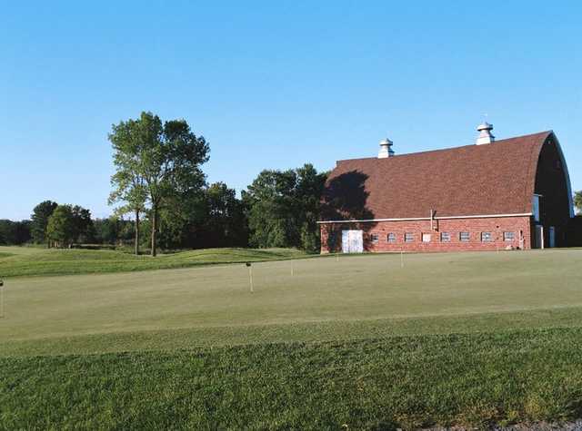 A view of the clubhouse and putting green at Tanners Brook Golf Club
